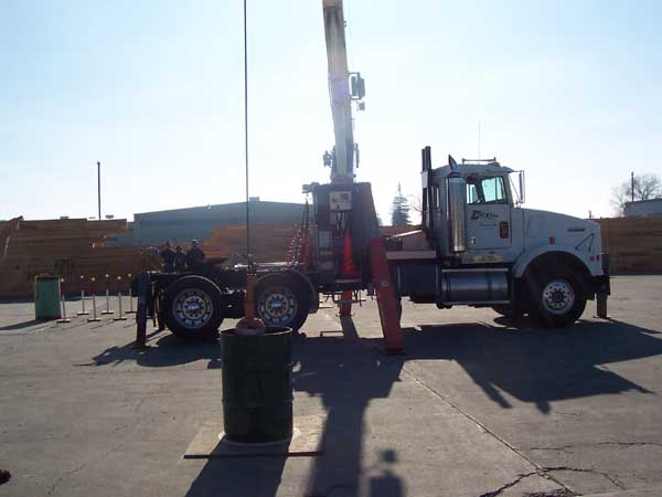 Crane placing overhead ball in two barrels