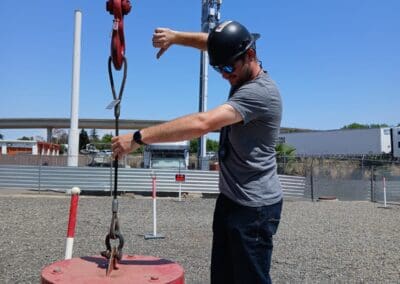 Crane Operator Certification Practical Exam Zig Zag Course - Hand Signals practiced as exam is taken (drop load block hand signal)