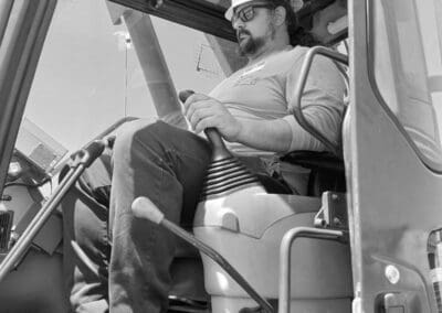 Crane operator in practical exam managing controls in crane cab (3)