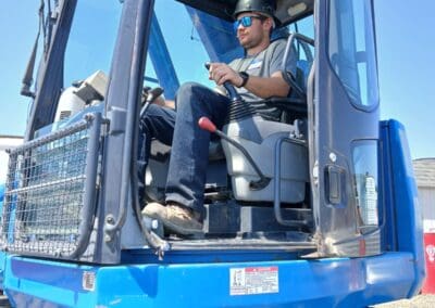 Crane operator in practical exam managing controls in crane cab (2)