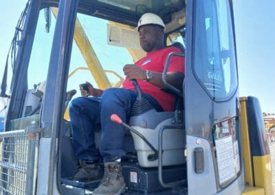 Crane operator in practical exam managing controls in crane cab (4)