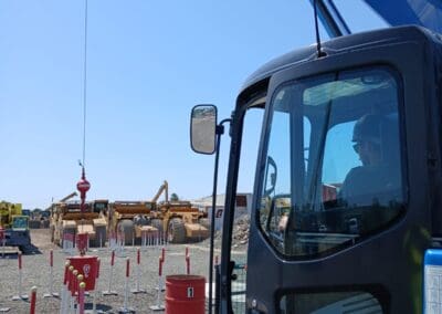 Crane operator in practical exam managing controls in crane cab (5) - zig zag course in background